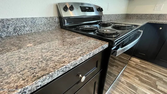 a stove top oven sitting inside of a kitchen