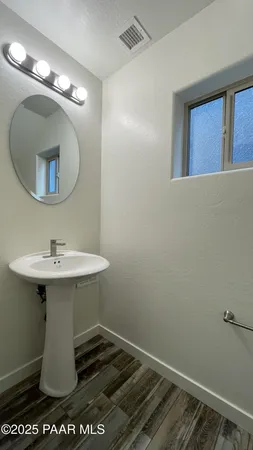 a bathroom with a sink toilet and mirror