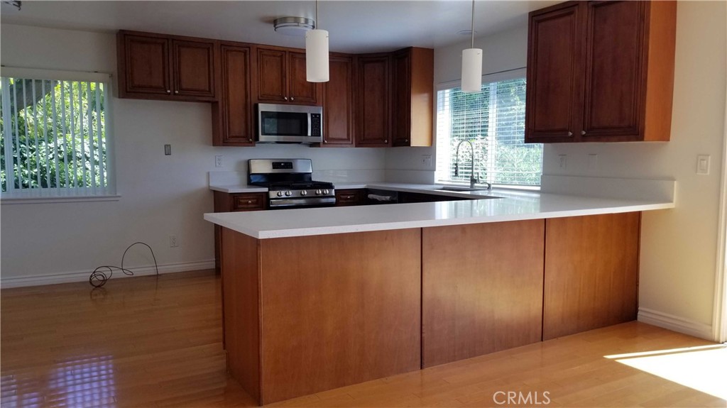 28012 Seashell Way Rancho Palos Verdes, CA 90275 - Photo 6 of 20 a kitchen with stainless steel appliances granite countertop wooden cabinets a stove a sink and a window