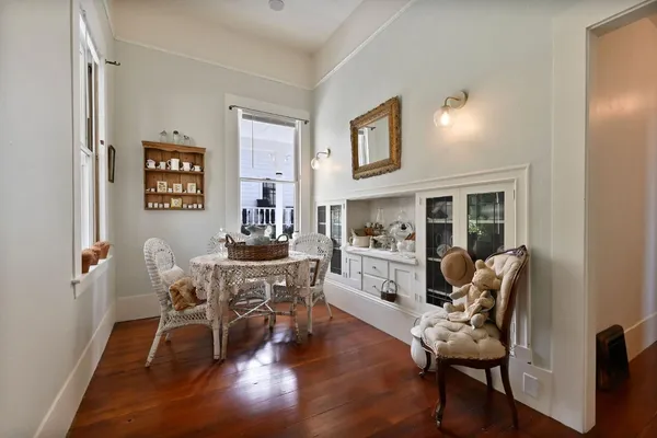 a kitchen with stainless steel appliances a stove a sink dishwasher and white cabinets with wooden floor