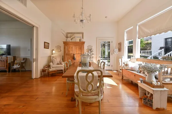 a view of a hallway with wooden floor and a bedroom