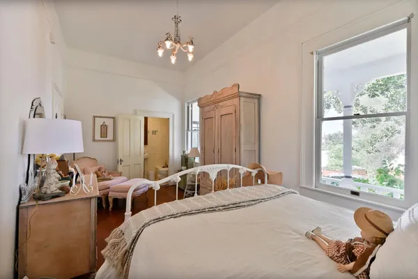 a view of a balcony with wooden floor and floor to ceiling window and garden