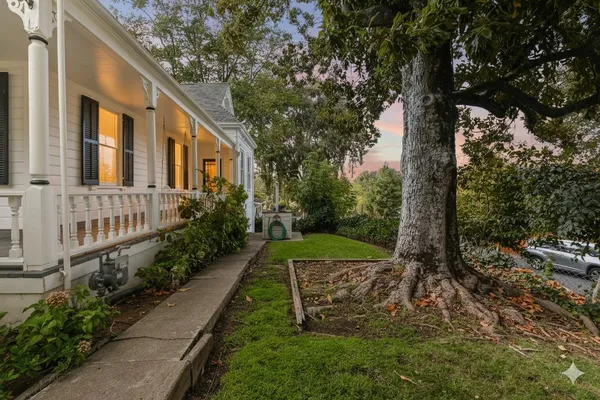 a living room with furniture chandelier and a fireplace