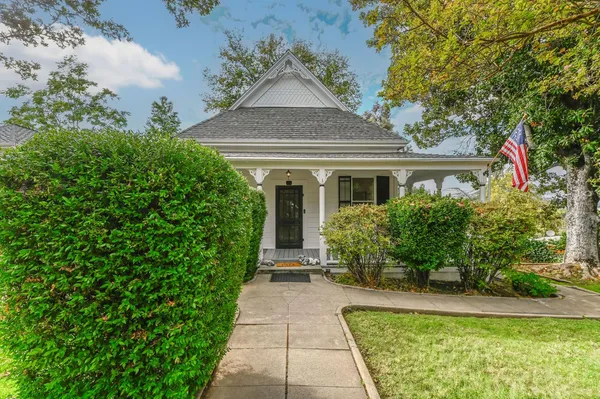 a front view of a house with garden