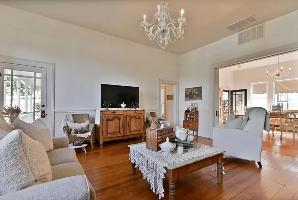 a living room with furniture and a chandelier