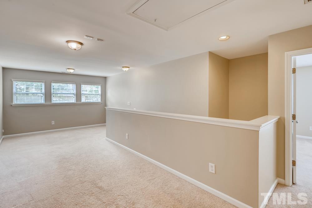 1258 Silver Beach Way Raleigh, NC 27606 - Photo 22 of 28 a view of wooden floor and windows in a room