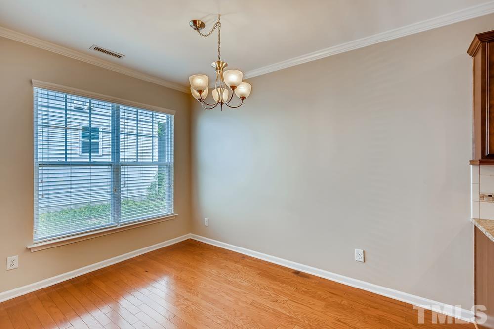 1258 Silver Beach Way Raleigh, NC 27606 - Photo 8 of 28 a view of empty room with wooden floor and fan