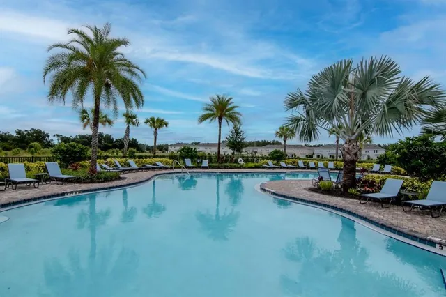 a swimming pool with outdoor seating and yard