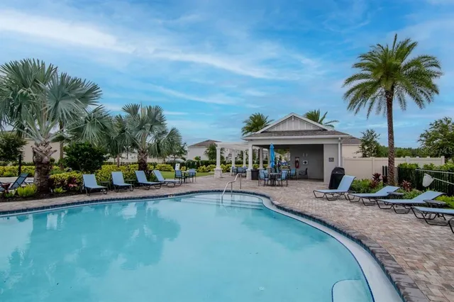 a view of a house with backyard and sitting area