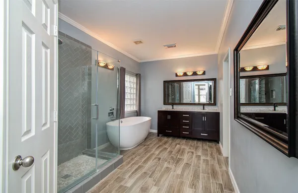 a spacious bathroom with a bathtub and shower