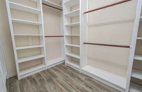 a view of staircase with railing and a large window
