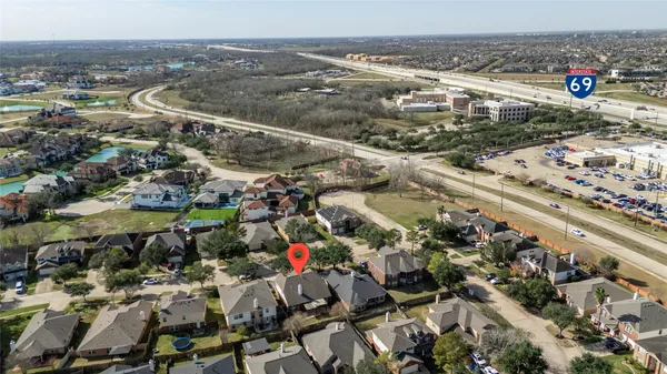 an aerial view of a house with a yard