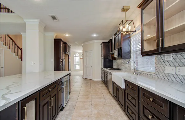 a large kitchen with stainless steel appliances granite countertop a refrigerator and a stove top oven