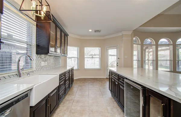 a large kitchen with stainless steel appliances a stove and a refrigerator