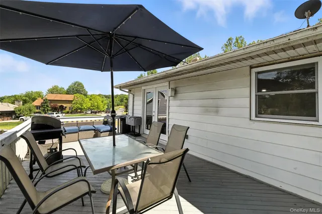 a view of balcony with outdoor seating and wooden floor