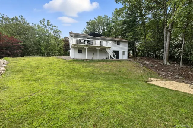 a view of a house with backyard porch and sitting area