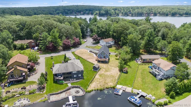 an aerial view of a house with outdoor space and lake view