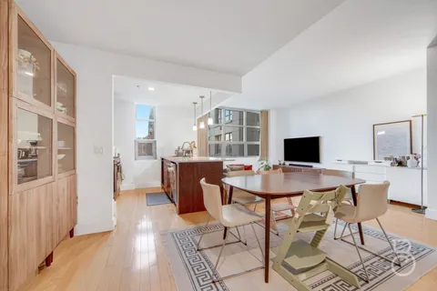 a view of a dining room with furniture and a wooden floor