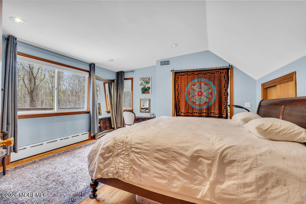 34 State Route Colts Neck, NJ 07722 - Photo 7 of 40 a bedroom with a large bed and a large window