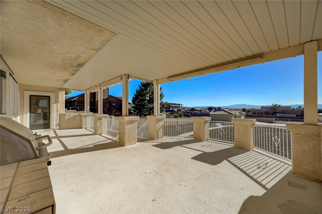 640 North Racetrack Road Henderson, NV 89015 - Photo 62 of 65 Unwind on the spacious covered patio, offering expansive views of the distant mountains and surrounding neighborhood.