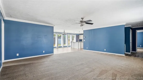 a kitchen with stainless steel appliances a stove top oven a refrigerator a sink and a chandelier