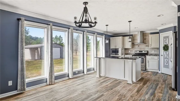 a view of a room with wooden floor and front door