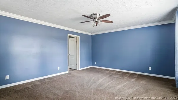a view of a livingroom with a chandelier fan and closet