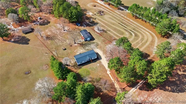 an aerial view of a house with a yard