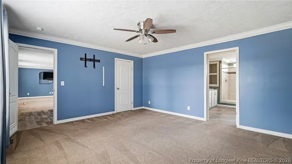 a view of a livingroom with a ceiling fan and window