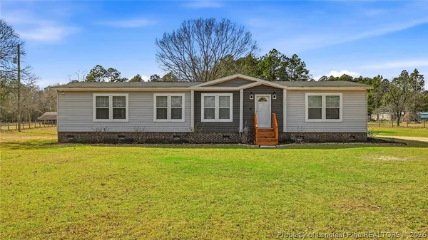 a front view of a house with yard