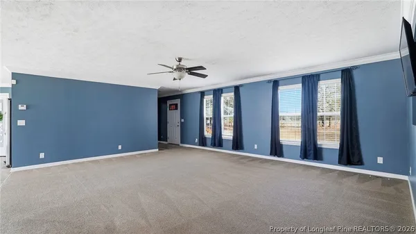 a view of an empty room with a ceiling fan
