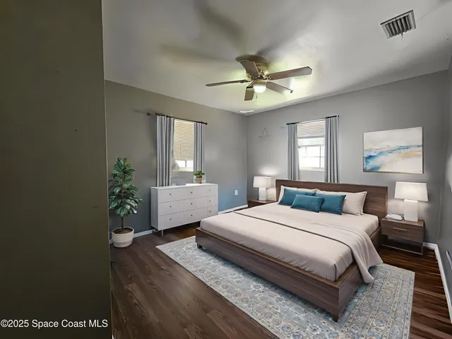 a bedroom with a large bed and a chandelier