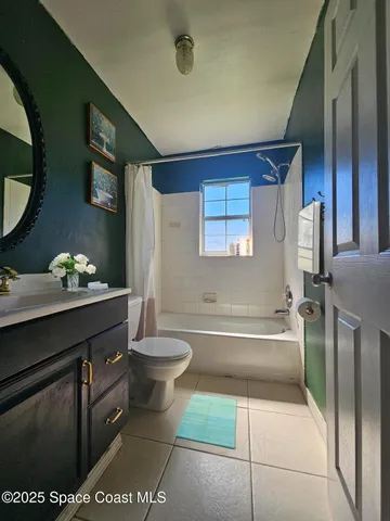 a spacious bathroom with a granite countertop sink a toilet and bathtub