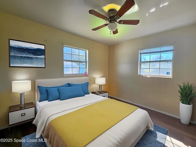 a bedroom with a large bed and a lamp