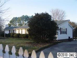 3129 Sikes Mill Road Monroe, NC 28110 - Photo 1 of 8 a front view of a house with garden