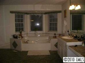 3129 Sikes Mill Road Monroe, NC 28110 - Photo 4 of 8 a bathroom with a sink and a mirror