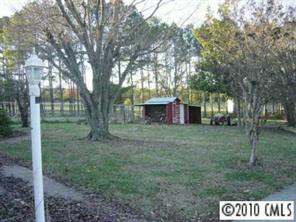 3129 Sikes Mill Road Monroe, NC 28110 - Photo 7 of 8 a view of a house with a yard