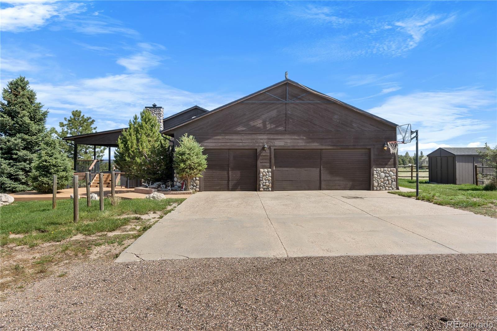 74 Rocky Cliff Road Elizabeth, CO 80107 - Photo 4 of 50 a front view of a house with a yard