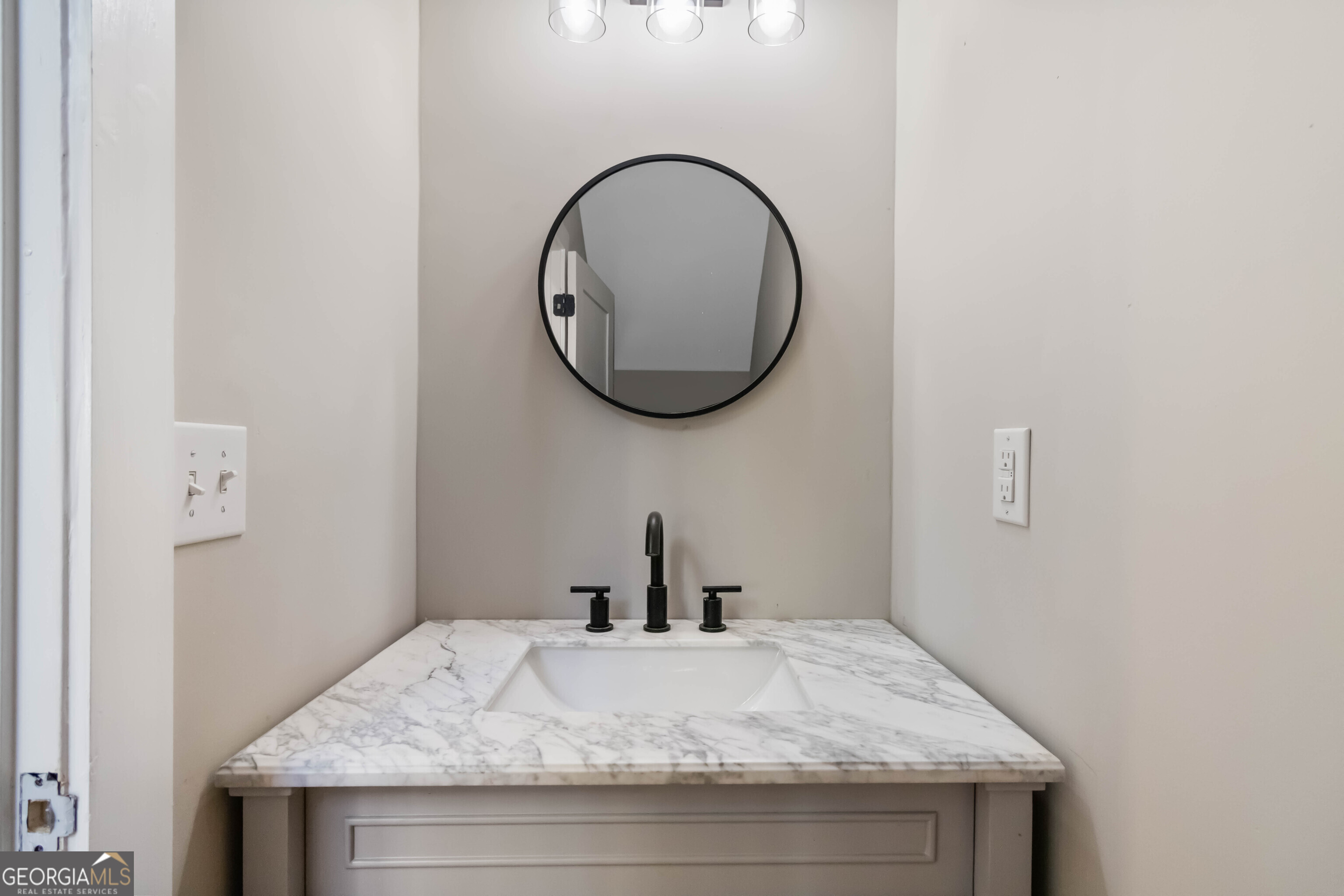 6960 Dockbridge Way Stone Mountain, GA 30087 - Photo 12 of 61 a bathroom with a granite countertop sink and a mirror