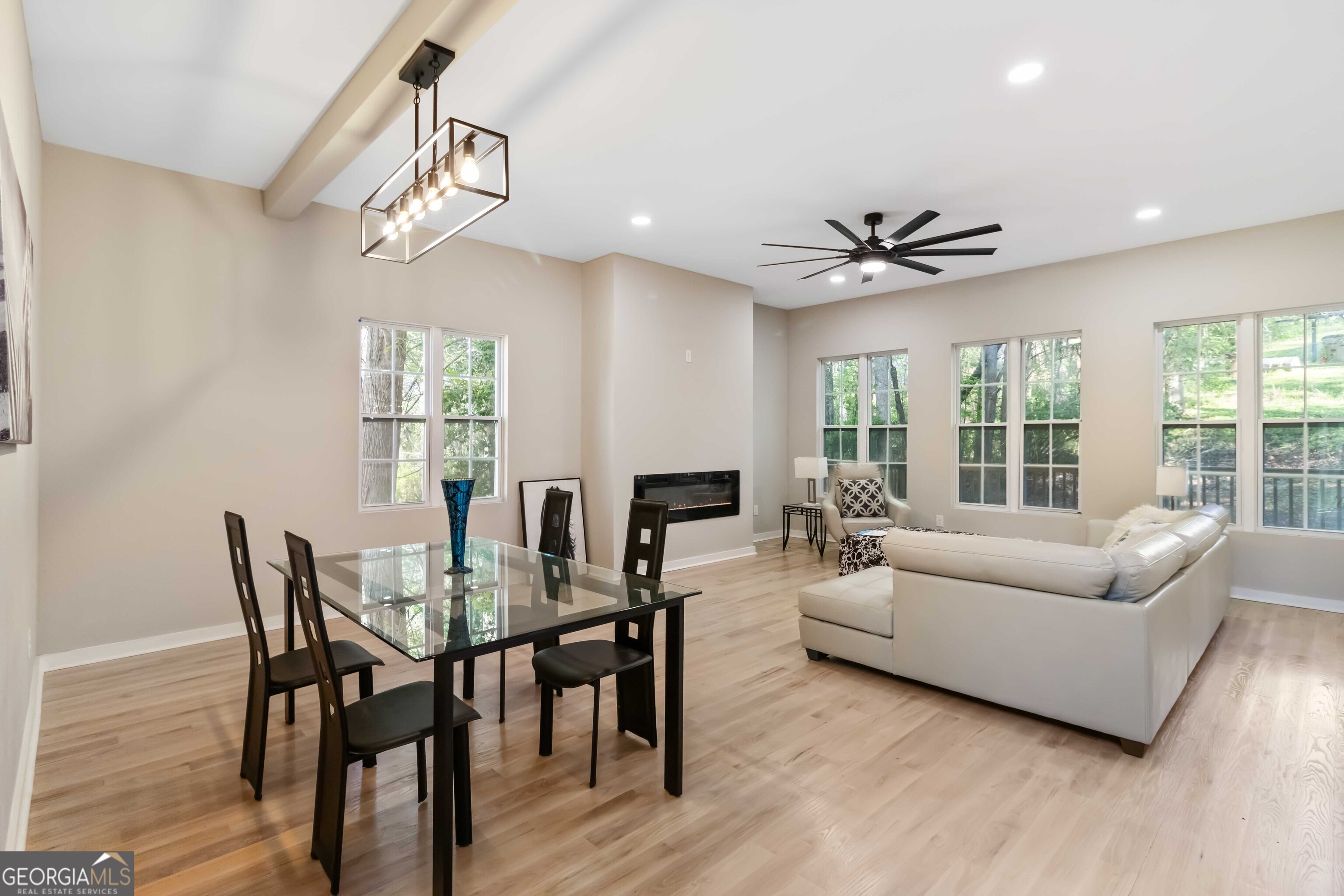6960 Dockbridge Way Stone Mountain, GA 30087 - Photo 14 of 61 a view of a dining room with furniture a chandelier and wooden floor