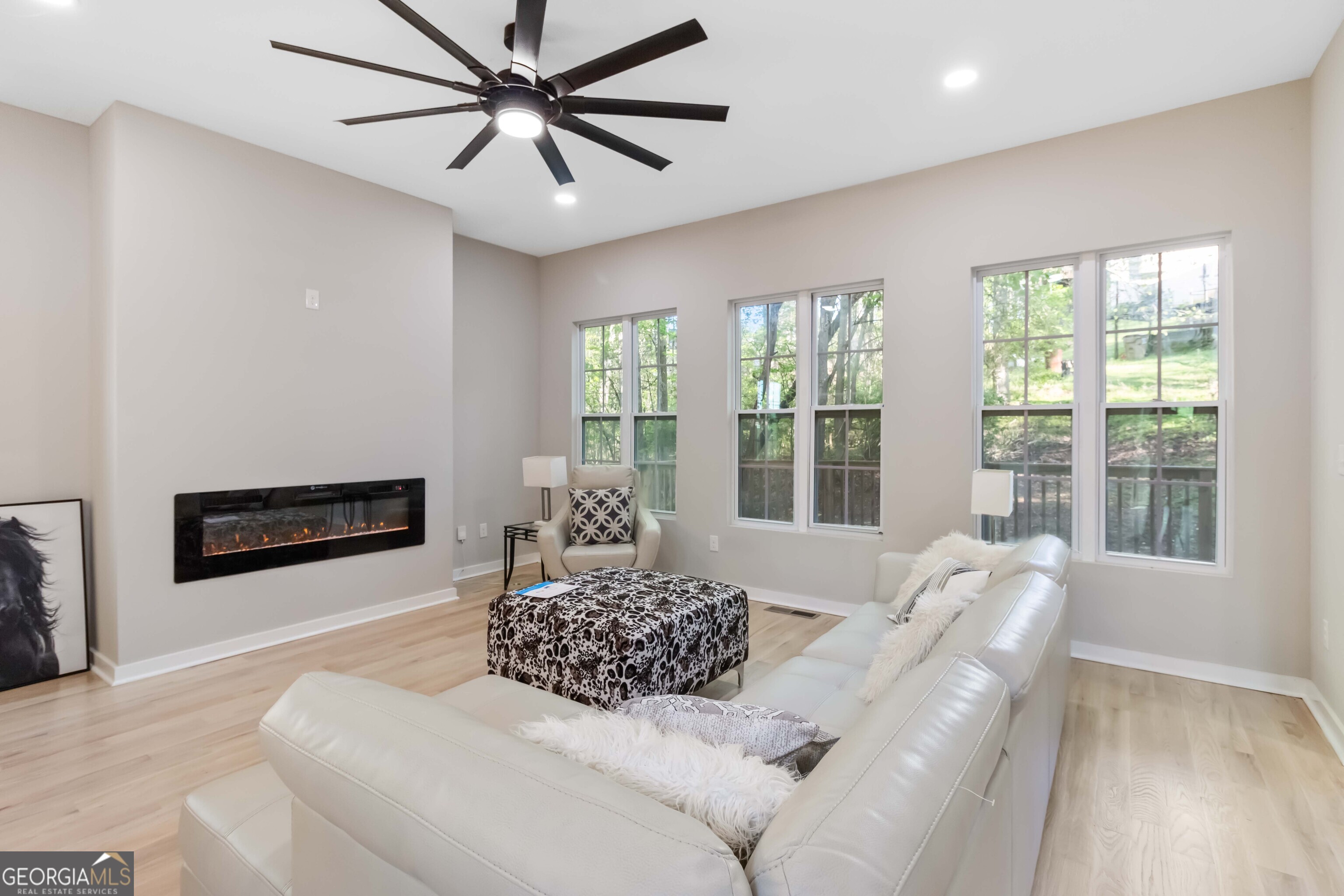 6960 Dockbridge Way Stone Mountain, GA 30087 - Photo 15 of 61 a living room with furniture and a floor to ceiling window