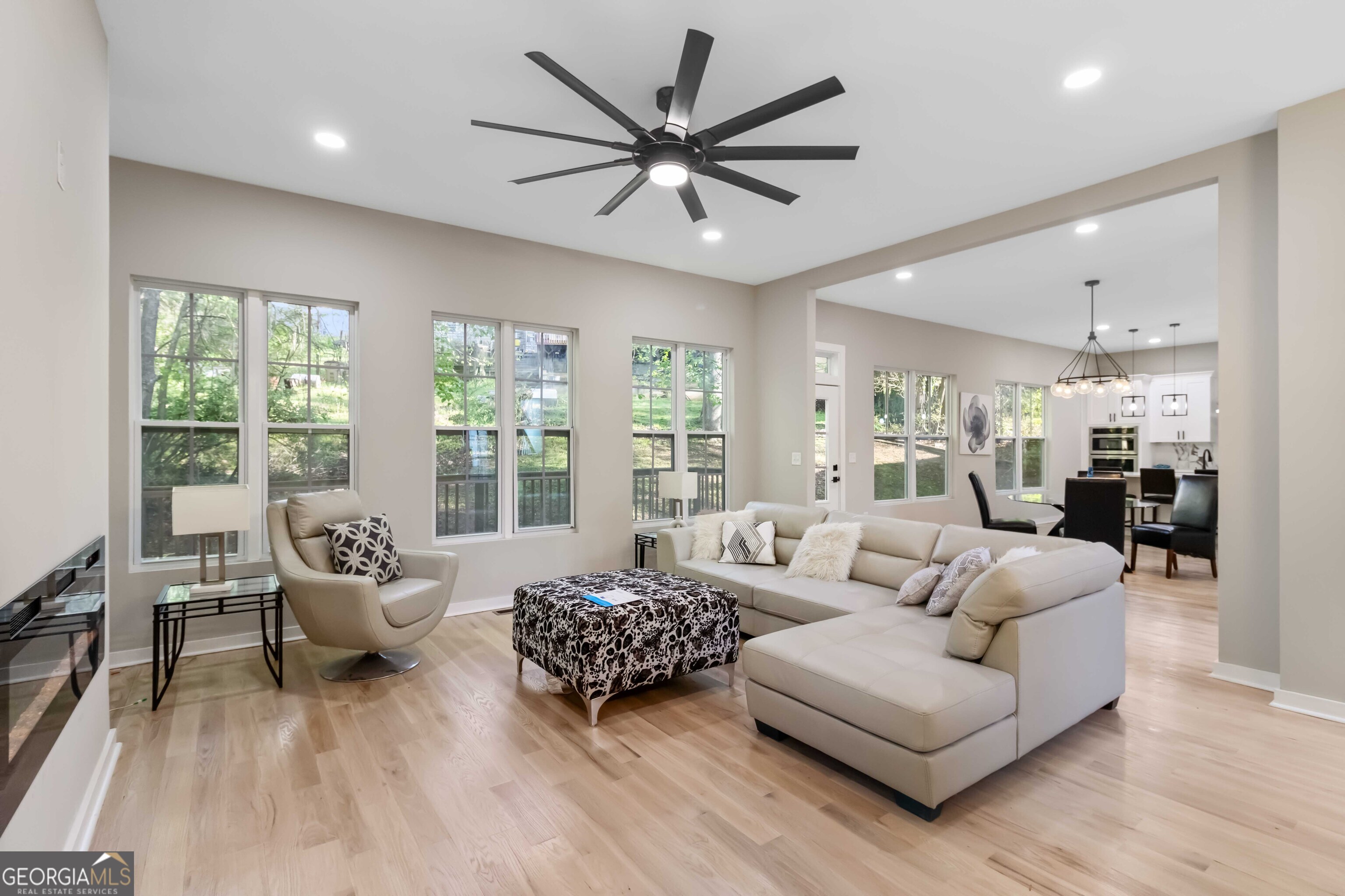 6960 Dockbridge Way Stone Mountain, GA 30087 - Photo 16 of 61 a living room with furniture and a large window