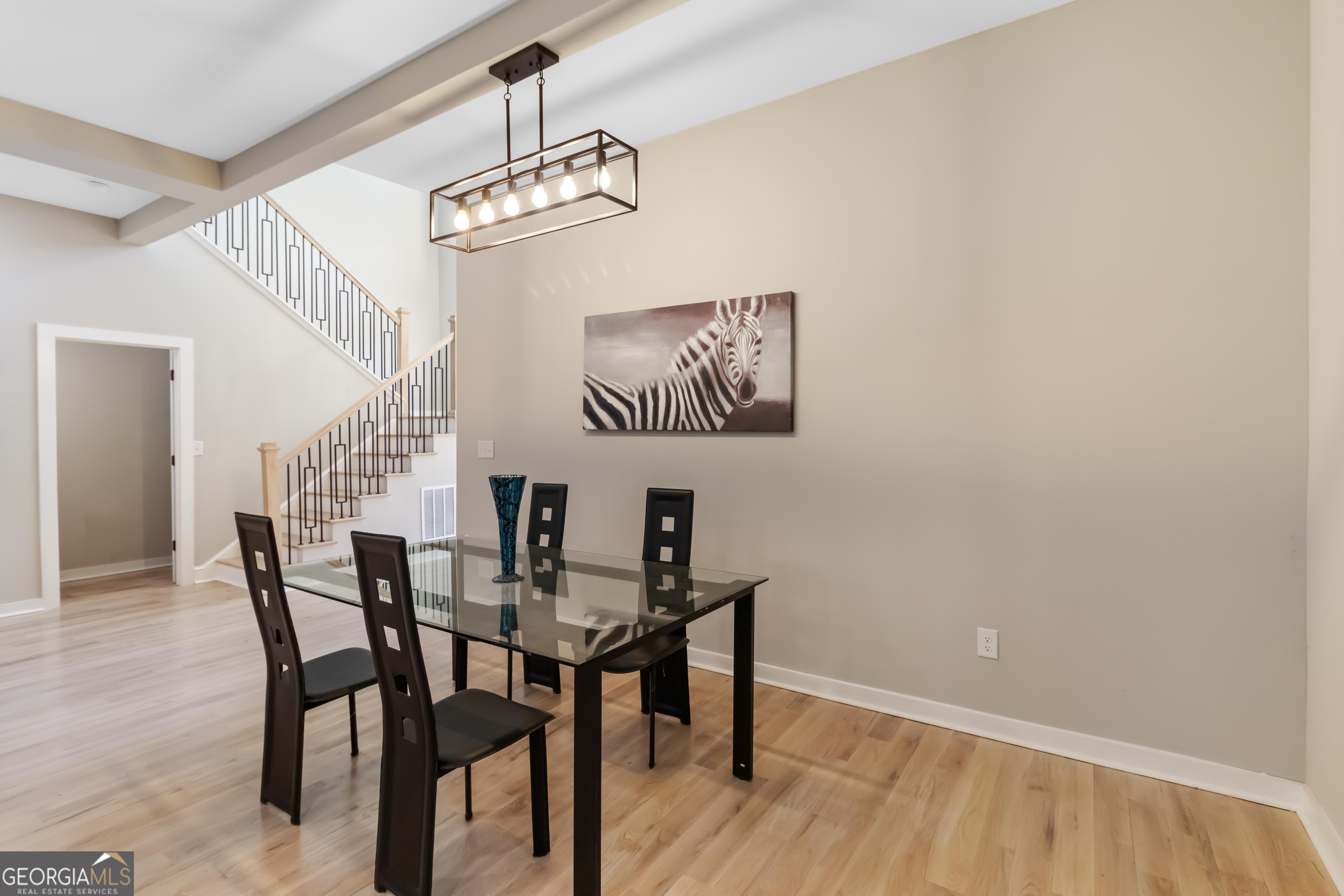 6960 Dockbridge Way Stone Mountain, GA 30087 - Photo 23 of 61 a view of a dining room with furniture and wooden floor