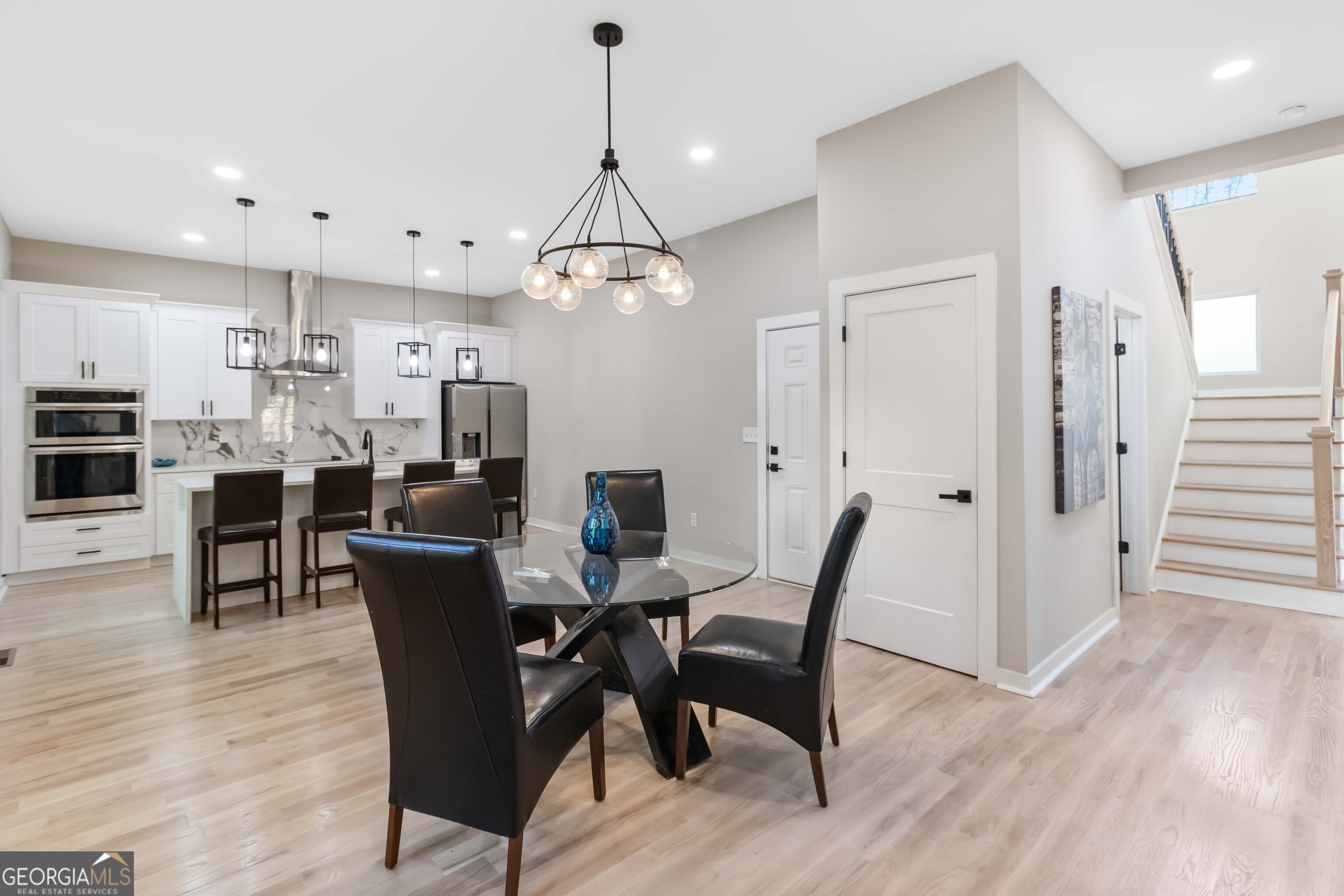 6960 Dockbridge Way Stone Mountain, GA 30087 - Photo 25 of 61 a view of a dining room with furniture and wooden floor