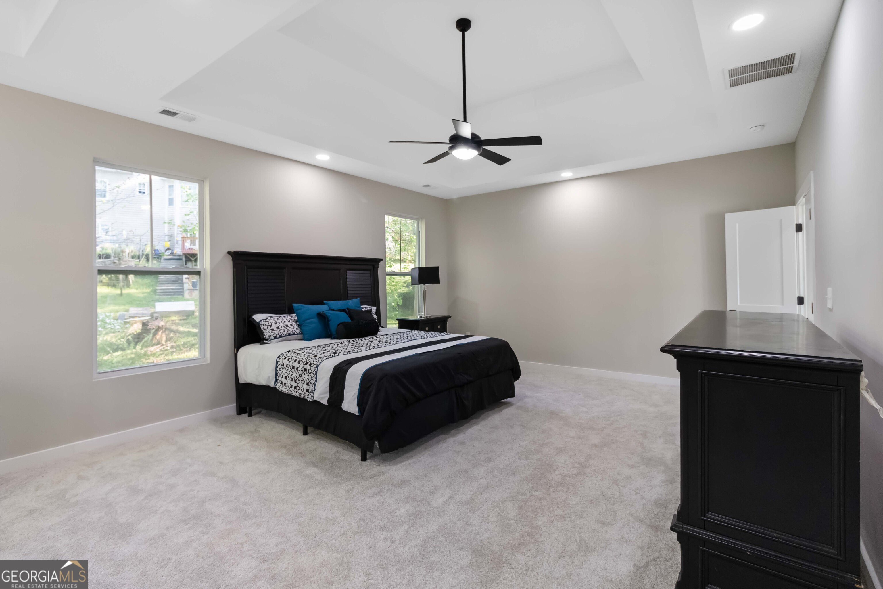 6960 Dockbridge Way Stone Mountain, GA 30087 - Photo 29 of 61 a bedroom with a bed ceiling fan and a window