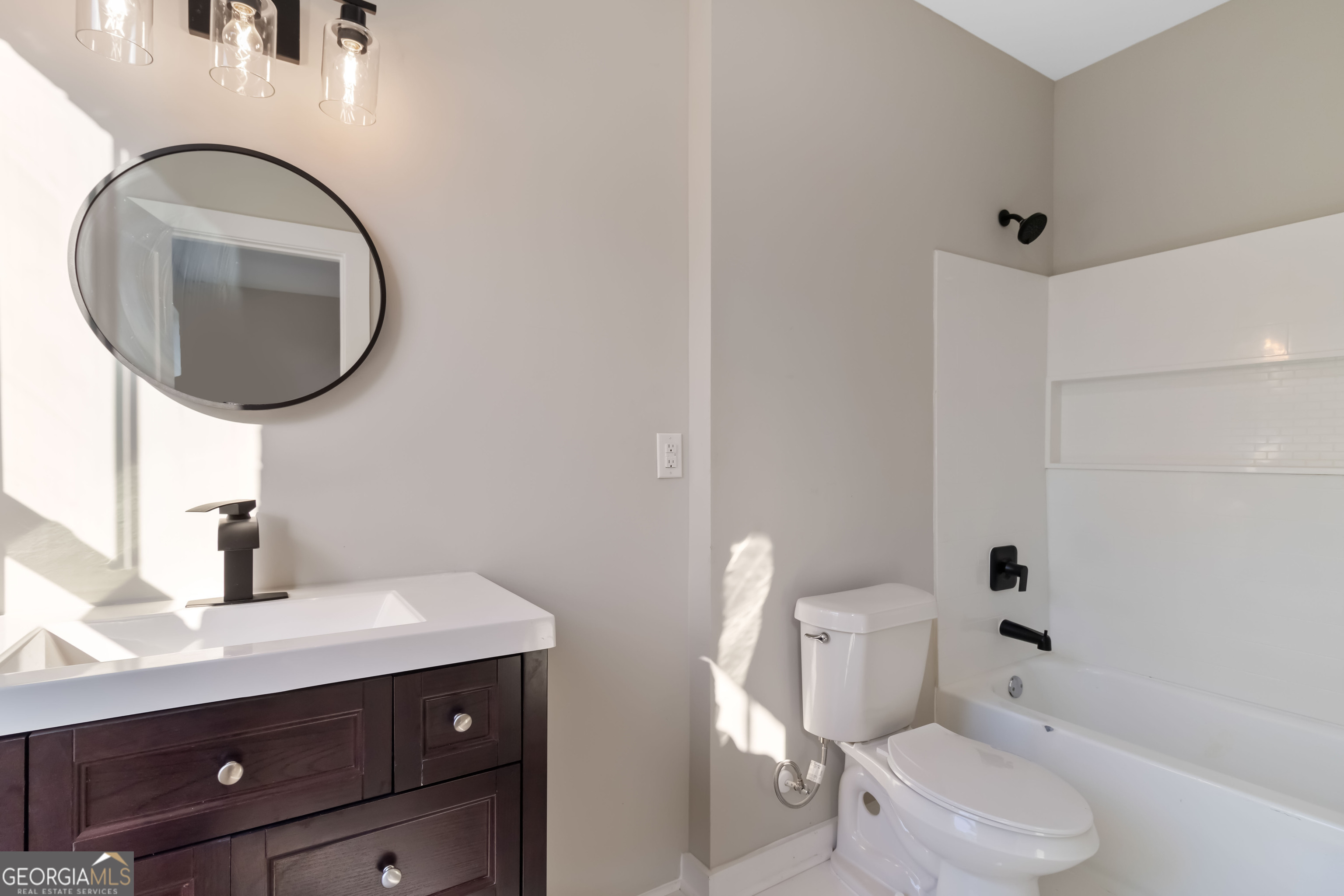 6960 Dockbridge Way Stone Mountain, GA 30087 - Photo 37 of 61 a bathroom with a toilet sink and mirror