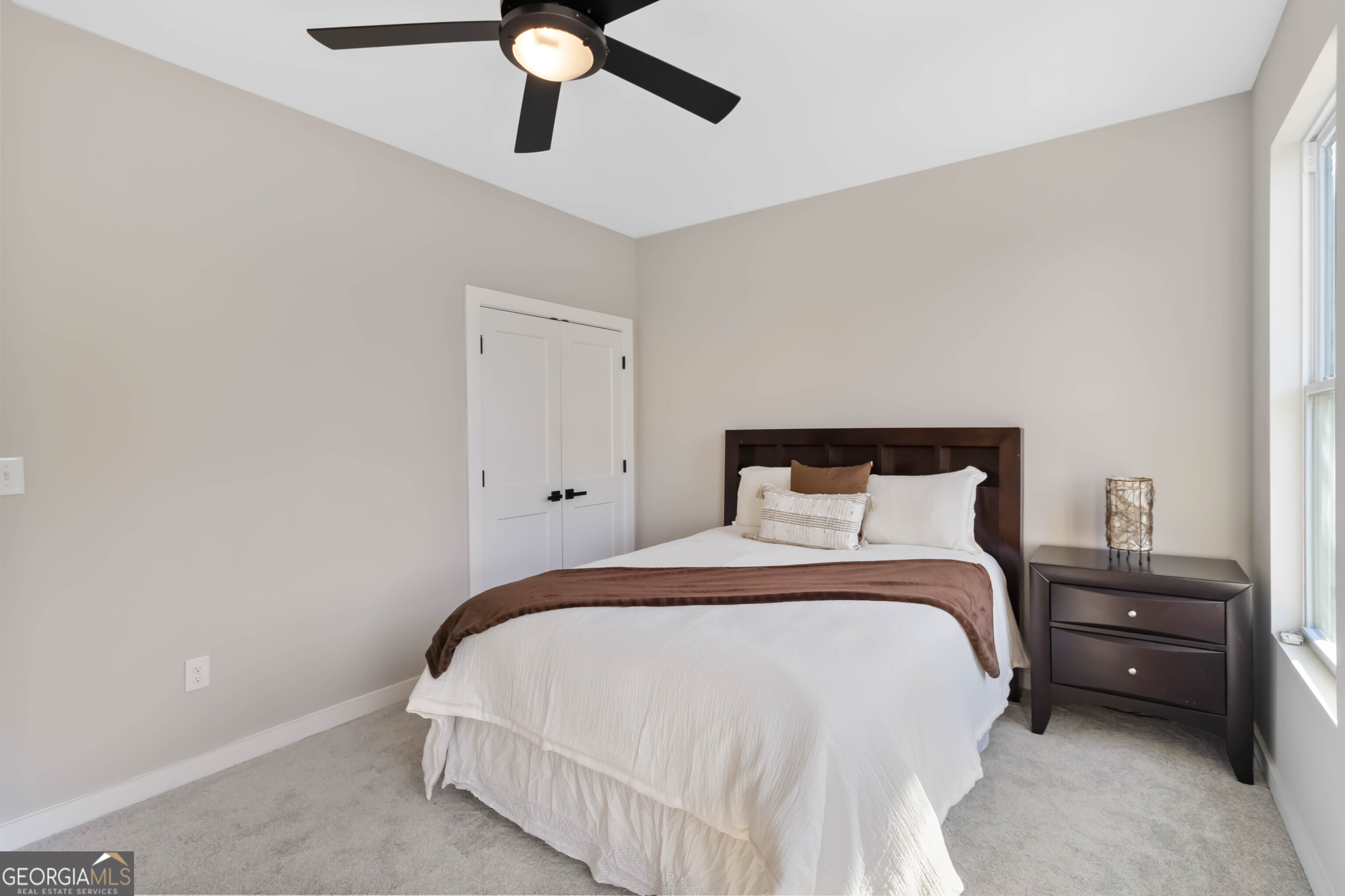 6960 Dockbridge Way Stone Mountain, GA 30087 - Photo 38 of 61 a bedroom with a bed and a chandelier