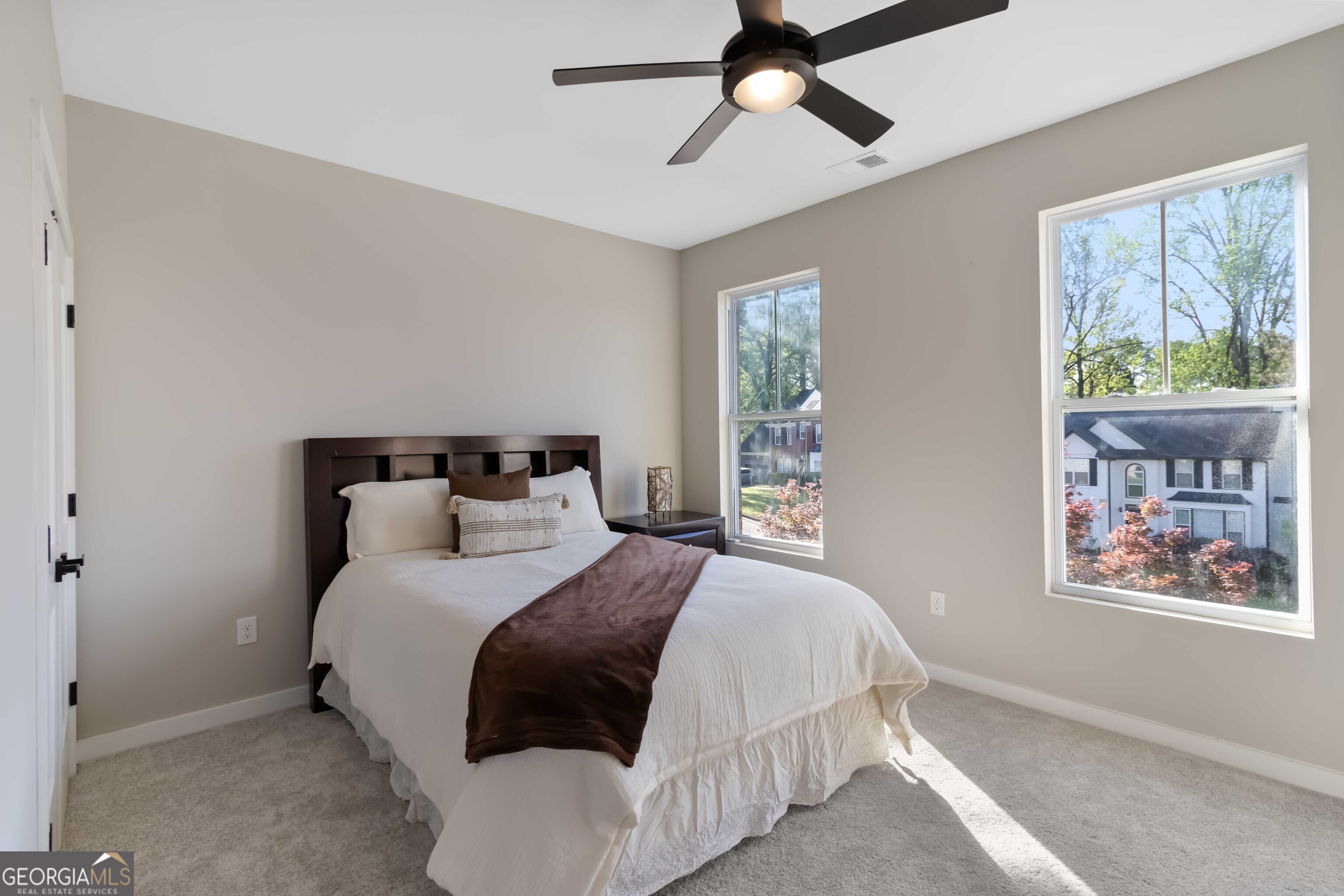 6960 Dockbridge Way Stone Mountain, GA 30087 - Photo 39 of 61 a bedroom with a large bed and a window