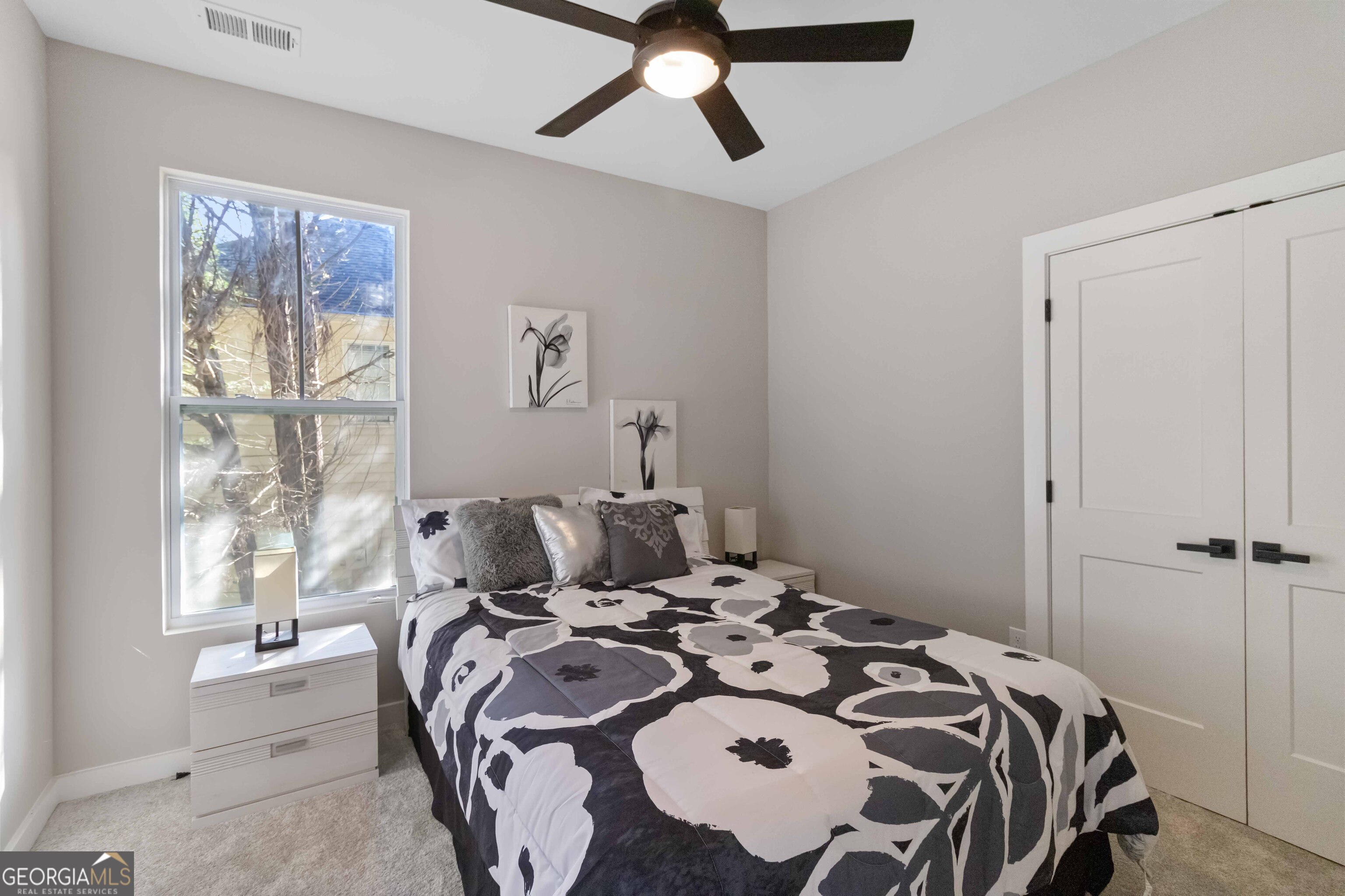 6960 Dockbridge Way Stone Mountain, GA 30087 - Photo 41 of 61 a bed sitting in a bedroom next to a window