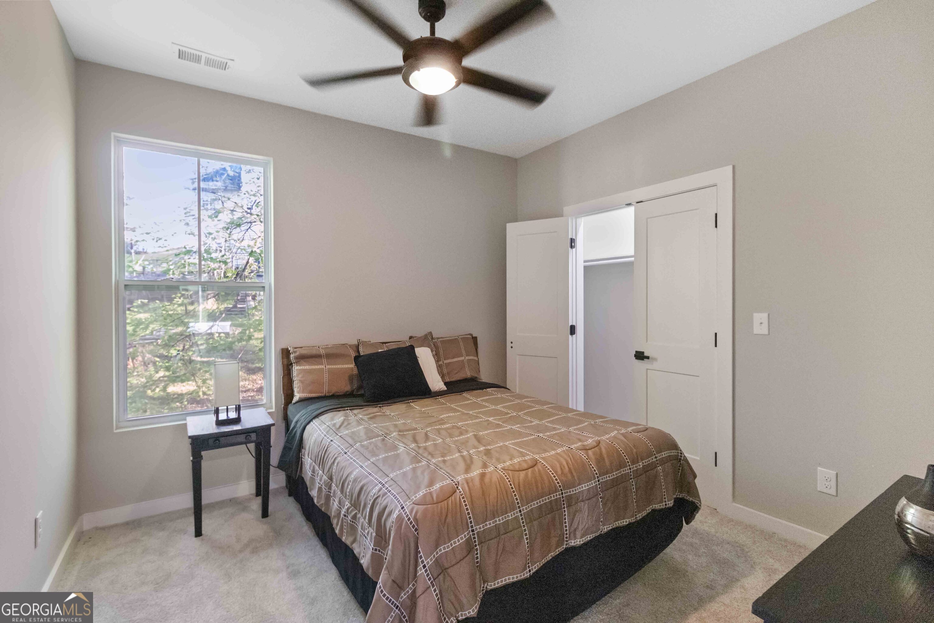 6960 Dockbridge Way Stone Mountain, GA 30087 - Photo 42 of 61 a bedroom with a large bed and a window